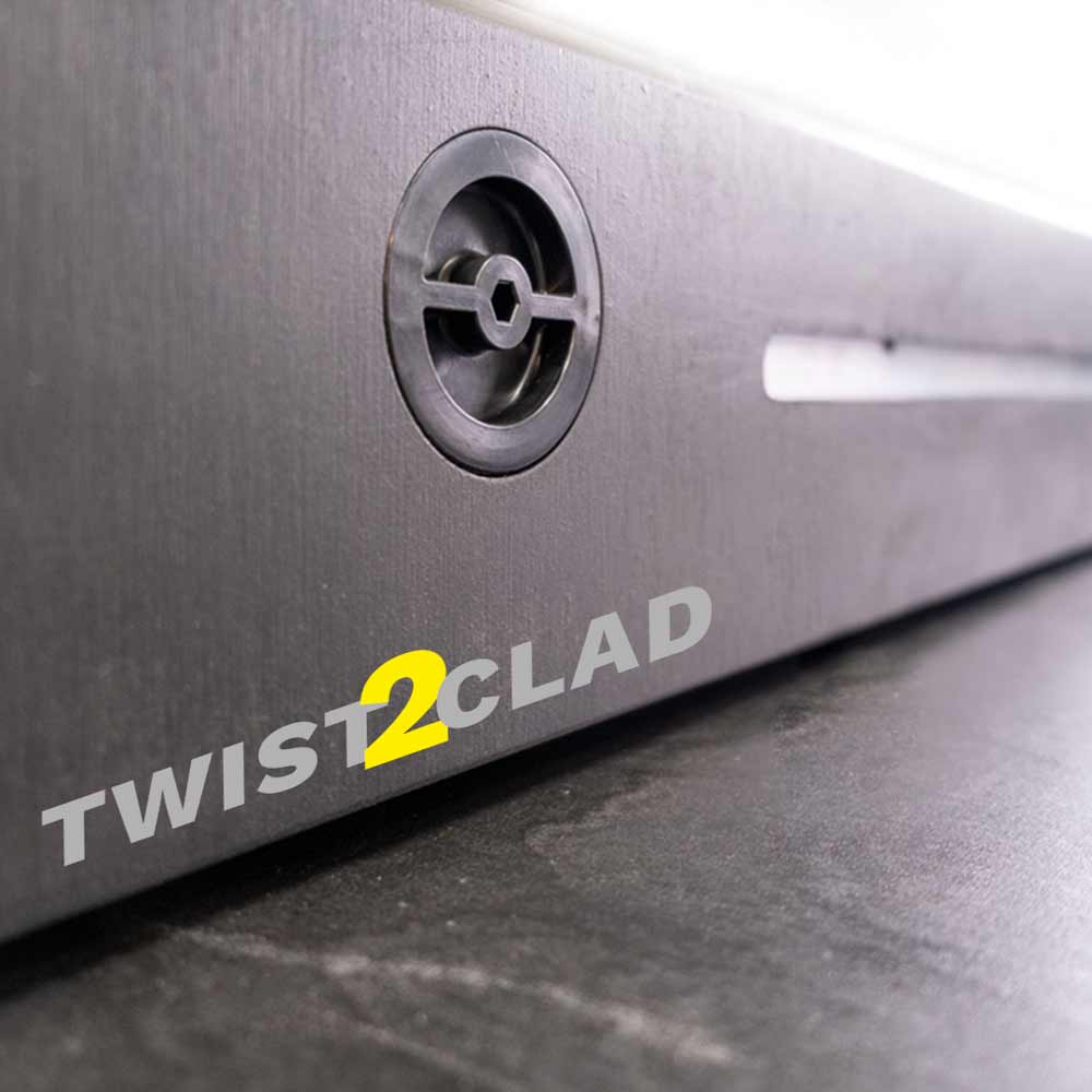 Nahaufnahme einer Metalloberfläche mit schwarzer Schraube und gelbem Twist2Clad Logo